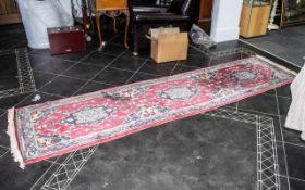 A Woollen Hall Runner, predominately reds, with geometric design. 32" wide x approx. 120" long.