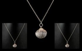 Silver Pendant In Form of a Shell, Suspended on a Silver Necklace.