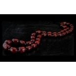 A Faux Cherry Amber Graduated Bead Necklace - Length 40 Inches.