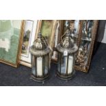 Pair of Brass Hanging Style Lanterns with candle holders, in a Moroccan style. Measure 21" tall.