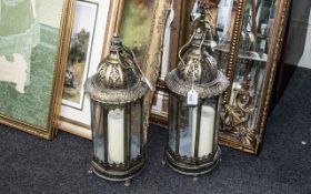 Pair of Brass Hanging Style Lanterns with candle holders, in a Moroccan style. Measure 21" tall.