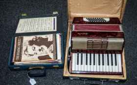 An Antique Piano Accordion with red marbelled body, marked Aloha, together with a teach yourself
