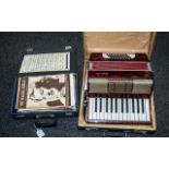 An Antique Piano Accordion with red marbelled body, marked Aloha, together with a teach yourself