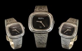 A Roy King Silver Wrist Watch, rectangular shaped case with black dial,