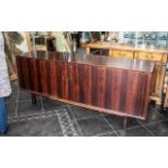 A Mid 20th Century Designer Rosewood Sideboard sliding front,