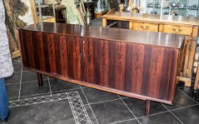 A Mid 20th Century Designer Rosewood Sideboard sliding front,