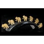 Tagua Nut Amazonian Hand Made Figure, depicting seven elephants walking in a row, mounted on a horn.