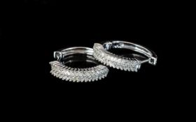 Diamond Pair of Hoop Earrings, closely set baguette cut diamonds of .