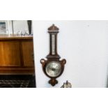 An Edwardian Mahogany Inlaid Barometer of shaped form. Height 34 inches.