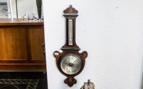 An Edwardian Mahogany Inlaid Barometer of shaped form. Height 34 inches.