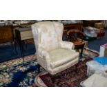 Two Antique Wing Back Armchairs, upholstered in cream embossed damask fabric, measure 41'' tall x