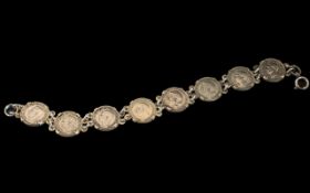 A Silver Coin Bracelet, set with eight s