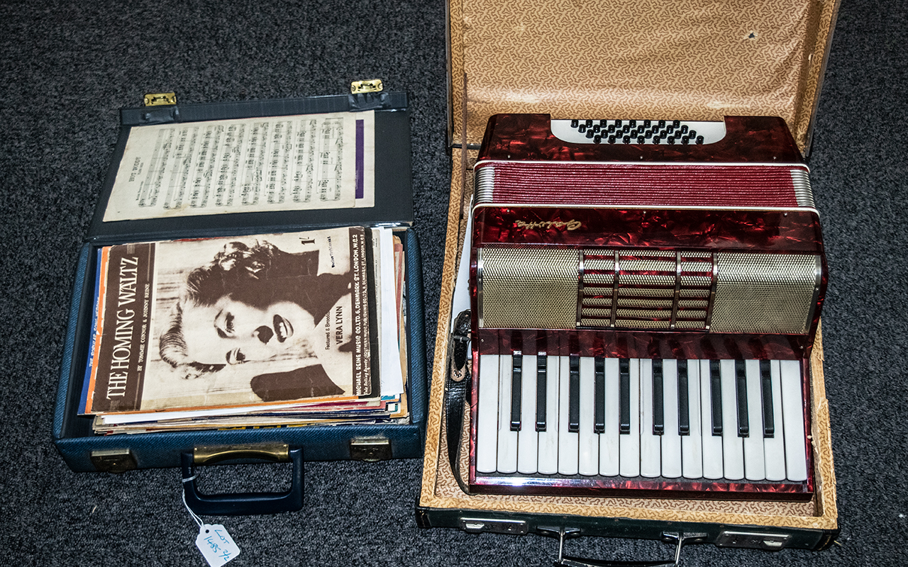 An Antique Piano Accordion with red marb