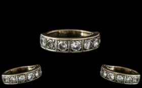 An 18ct Gold Half Eternity Ring, set with seven round modern brilliant cut diamonds.
