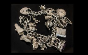 A Fine Vintage Silver Charm Bracelet Loaded with 18 Silver Charms.