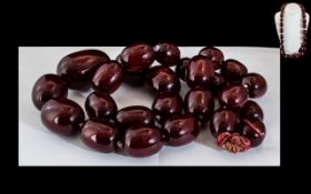 A Faux Cherry Amber Graduated Bead Necklace, length 28", weight 230 grams.