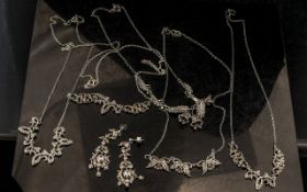 A Collection of Five Silver Marcasite Necklaces hung on silver tone chains,