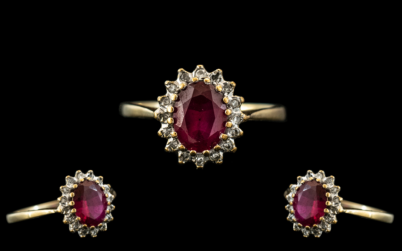 A 9ct Gold Red Stone Dress Ring surrounded by small diamonds,