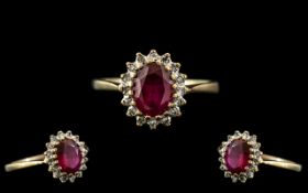 A 9ct Gold Red Stone Dress Ring surrounded by small diamonds,