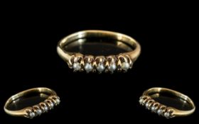 An Antique Gold Ring set with five seed pearls, stamped 14k. Size M.