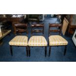 Three Mahogany Dining Chairs with carved back rests, upholstered seats, raised on column legs.