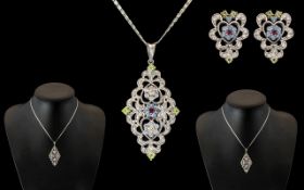 An 18ct White Gold Pendant & Chain with Matching Earring, set with faceted coloured stones.