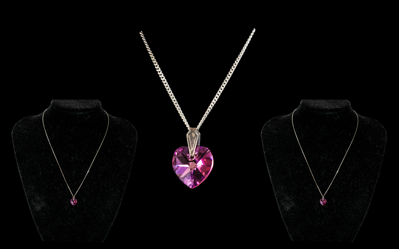 Large Heart Shaped Pink Stone Suspended on Silver Chain.