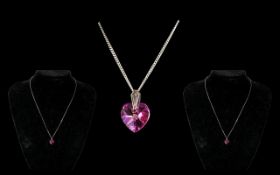 Large Heart Shaped Pink Stone Suspended on Silver Chain.