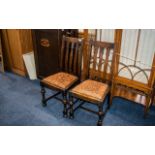 A Pair of Early 20thC Oak Dining Chairs drop in seats, turned front legs.