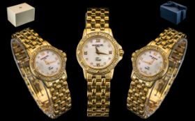 Ladies Gold Tone Raymond Weil Wristwatch mother of peal dial, diamond dot and Roman Numerals.