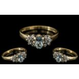 9ct Gold Aquamarine and Diamond Cluster Ring central oval blue stone,