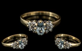 9ct Gold Aquamarine and Diamond Cluster Ring central oval blue stone,