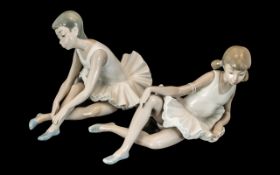 Two Nao Ballet Figurines, depicting young ladies warming up for ballet.