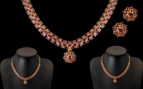 An Indian 22ct Gold Ruby Set Fringe Necklace, with matching earrings.