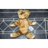 Mohair Early 20th Century Jointed Teddy Bear, straw filled. Length 12". One glass eye missing.