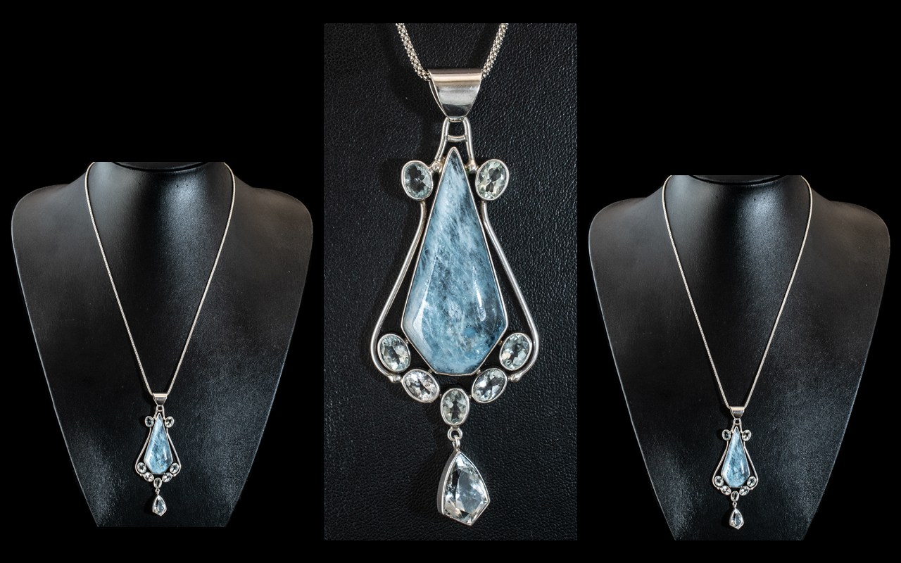 A large Unusual Sterling Silver Pendant Set with A Large Aquamarine along with Seven Oval and one