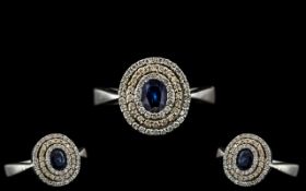 14ct White Gold - Ladies Attractive Blue Sapphire and Diamond Set Ring of Circular Form.