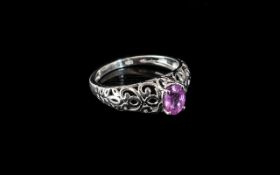 Pink Sapphire Solitaire Ring, size Q; a pink sapphire of just over 1ct, oval cut and set in an