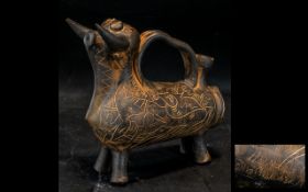 A Jug stylised in the form of a Bull measuring 9 by 9 inches. Probably Spanish. Signed to base.