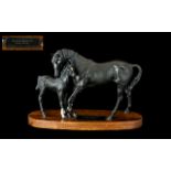 Beswick 'Black Beauty & Foal' raised on a wooden base. Measures approx 8" tall x 12" wide.