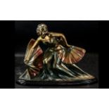 An Art Deco Style Centre Piece depicting a dancing girl with fans, Raised on an oval plinth,