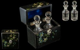 A Black Lacquered Papier Mache Small Casket, containing two glass scent bottles,