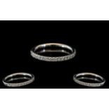 A Platinum Diamond Half Eternity Ring set with round, modern brilliant cut diamonds,