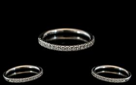 A Platinum Diamond Half Eternity Ring set with round, modern brilliant cut diamonds,