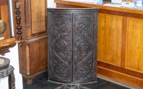 George III Oak Bow Fronted Corner Cupboard, later carved floral decoration, with three fixed