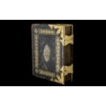Large Family Bible in tooled leather cover with brass ornate corners and closures.