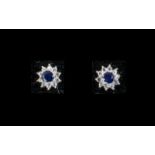 Sapphire Halo Stud Earrings, round cut solitaire blue sapphires, each framed with a halo of