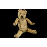 Early 20th Century Straw Filled Jointed Teddy Bear, with Merrythought tag to foot.