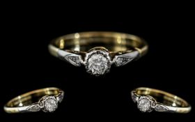 An 18ct Gold Diamond Ring, illusion set round cut diamond, between diamond set shoulders,
