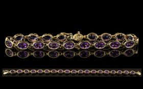 Ladies Attractive and Good Quality 9ct Gold Amethyst Set Line Bracelet. Full Hallmark for 9ct - 9.